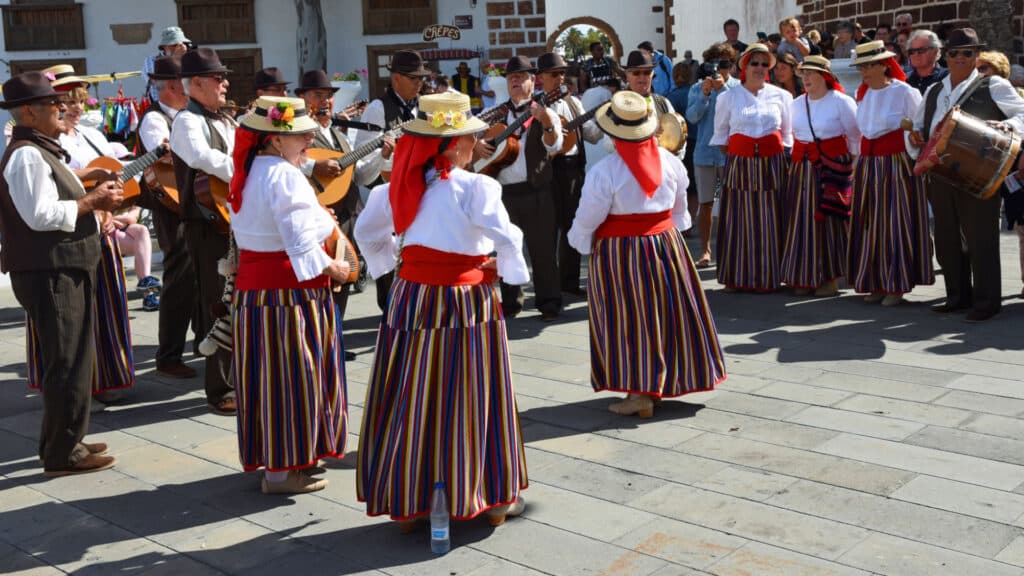 Dancers and musicians performing in traditional dress in market place.