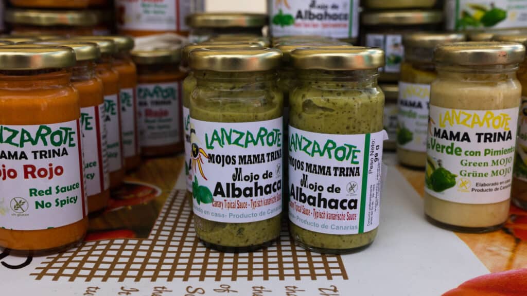 Lanzarote, canned jars of traditional Canarian green mojo sauce on a shop counter in Teguise