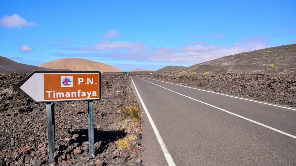 A volcanic landscape on Timanfaya, Spain with road sign