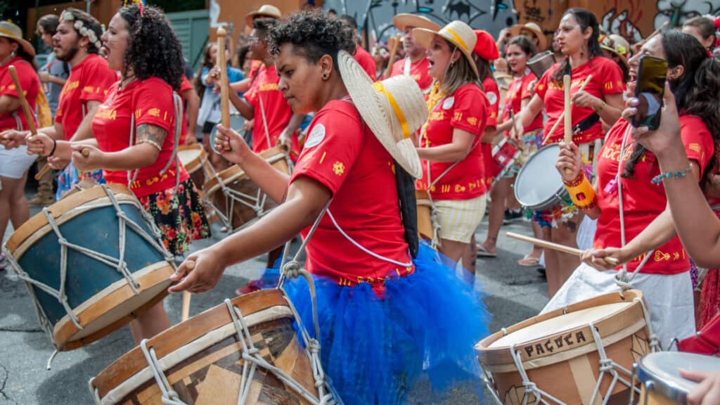Revelers enjoy a samba band at a street carnival.