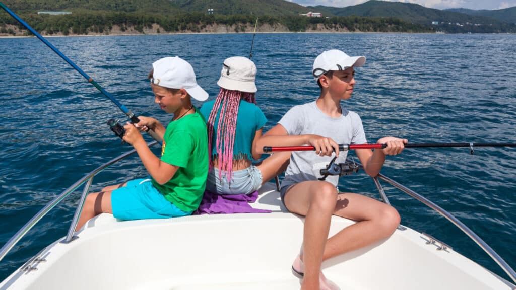 Two boys and one girl have fishing on a sailboat, deep-sea fishing trip